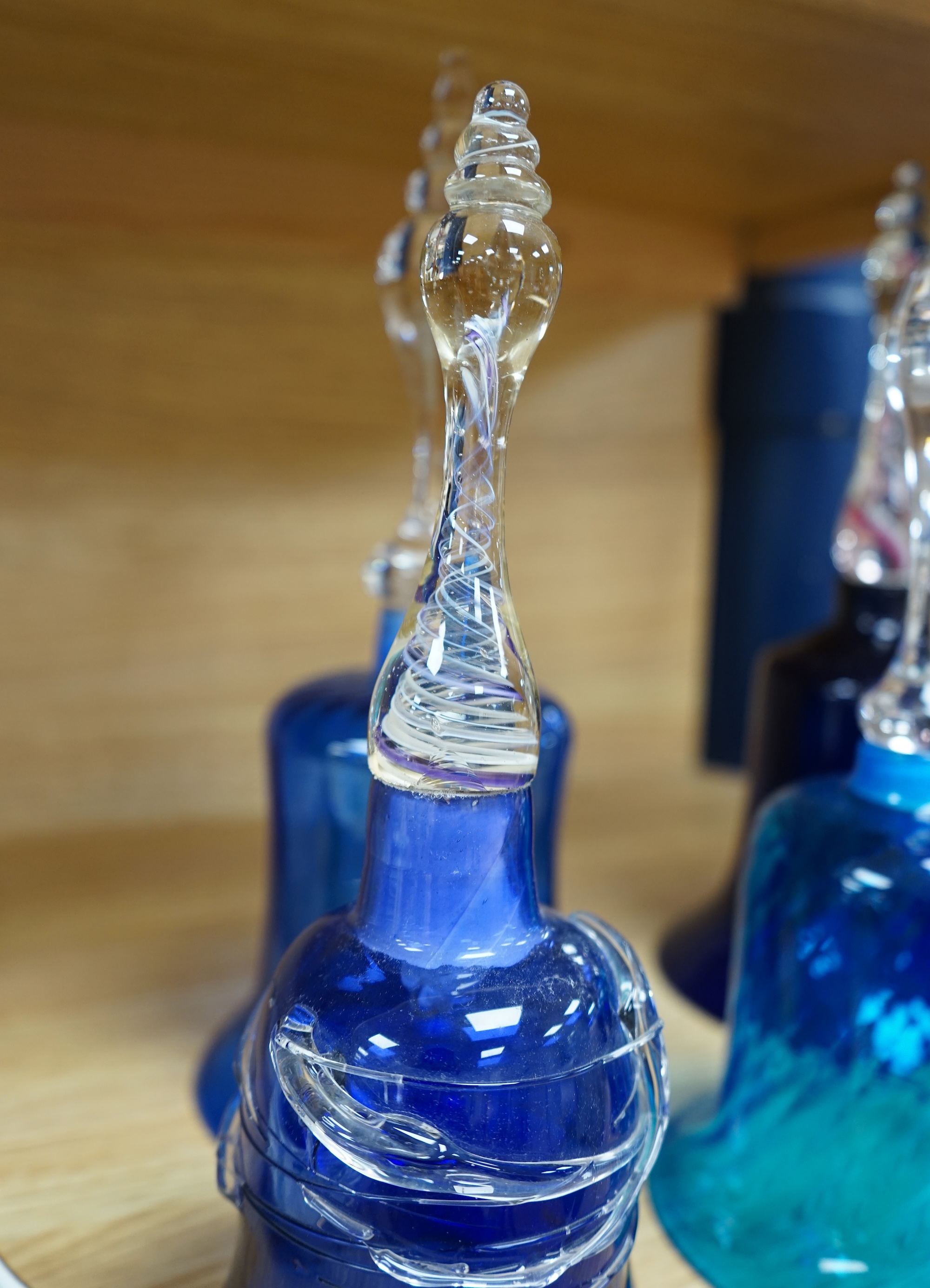 Five Victorian blue glass bells, two with air twist handles, 32cm high. Condition - fair to good